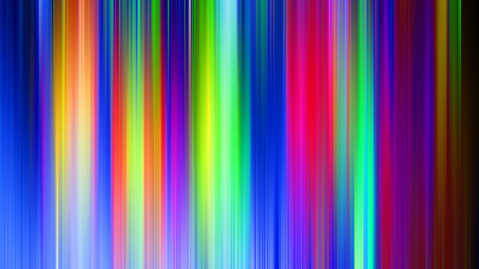 Vertikale, unscharf auslaufende Streifen in Blau, Gelb, Grün, Rot und Violett auf dunklem Grund