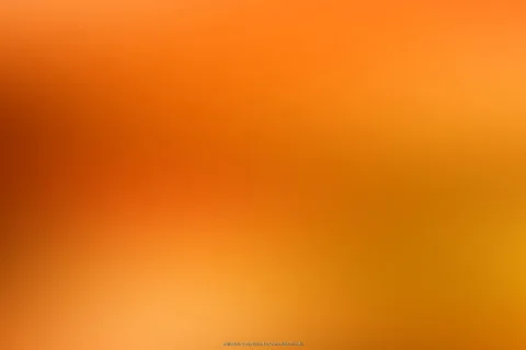 Unscharfer Verlauf in Orange und Ocker, dunklere Töne links oben, helles Leuchten unten links und rechts.