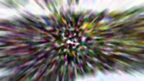 Abstraktes Bild mit bunten Farbstreifen, die von einem hellen Zentrum radial nach außen laufen, grob gepixelt.