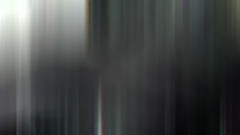 Abstrakte Aufnahme mit senkrechten Schlieren in Grau-, Weiß- und Schwarztönen, links heller, rechts dunkler.
