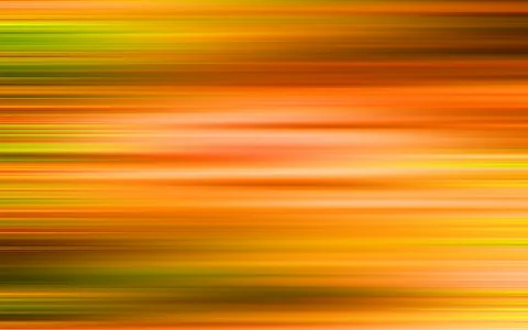 Abstrakte, horizontal verwischte Streifen in Orange, Gelb, Grün und Braun, die von links nach rechts ineinanderlaufen.
