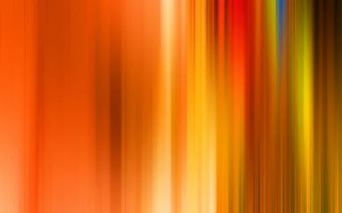 Abstrakte vertikale Streifen in Orange, Rot, Gelb und Grün, die von links nach rechts ineinander verlaufen und unscharf wirken.
