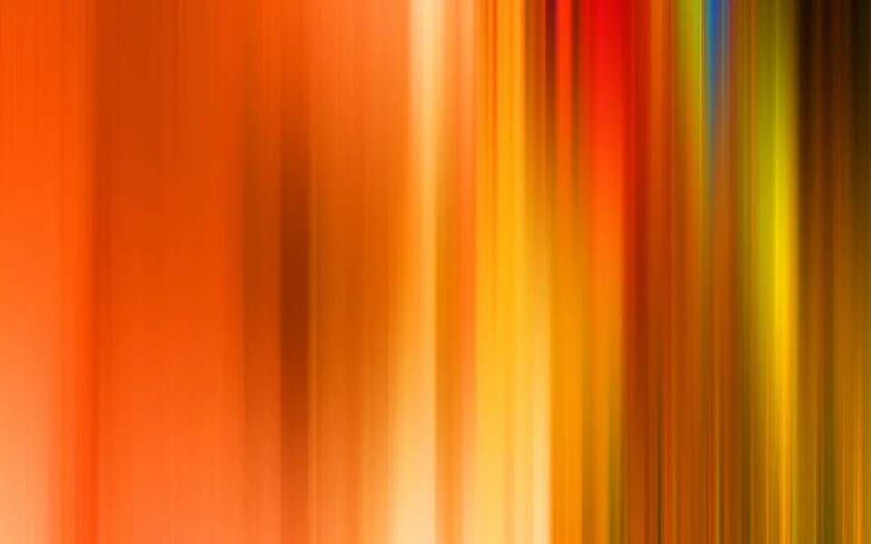 Abstrakte vertikale Streifen in Orange, Rot, Gelb und Grün, die von links nach rechts ineinander verlaufen und unscharf wirken.