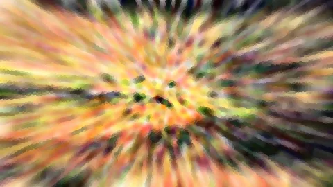 Abstrakte radiale Unschärfe mit gelben, orangefarbenen und grünen Streifen, die von einem dunklen Zentrum nach außen strahlen.