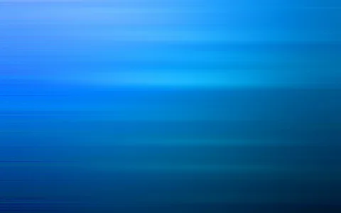 Horizontal verwischte Lichtstreifen in verschiedenen Blautönen, von hellem Türkisblau in der oberen Mitte bis zu dunklem Marineblau am unteren Rand.