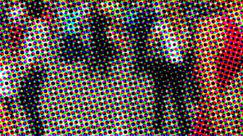 Dichtes Raster aus bunten Punkten in Rot, Grün, Blau, Gelb und Cyan, durchsetzt von dunklen schwarzen Flächen.