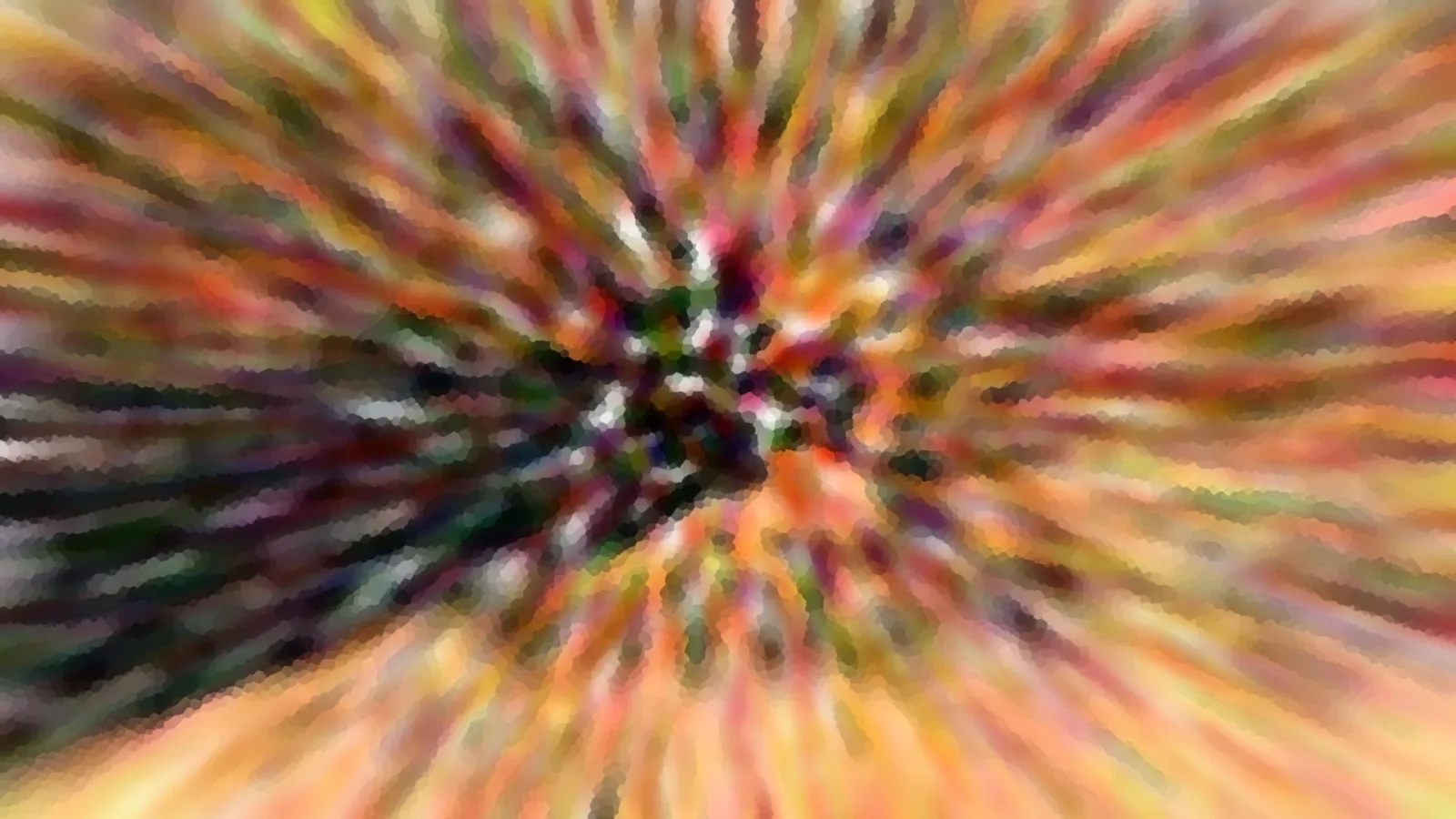 Abstrakte Aufnahme mit radial verwischten Farbstreifen in Rot, Orange, Gelb und Grün, die von einem dunklen Zentrum nach außen strahlen.