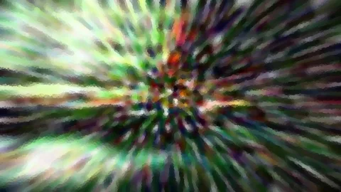 Abstrakte Komposition aus radial verlaufenden, bunten Streifen in Grün, Rot und Violett mit unscharfem Zentrum.