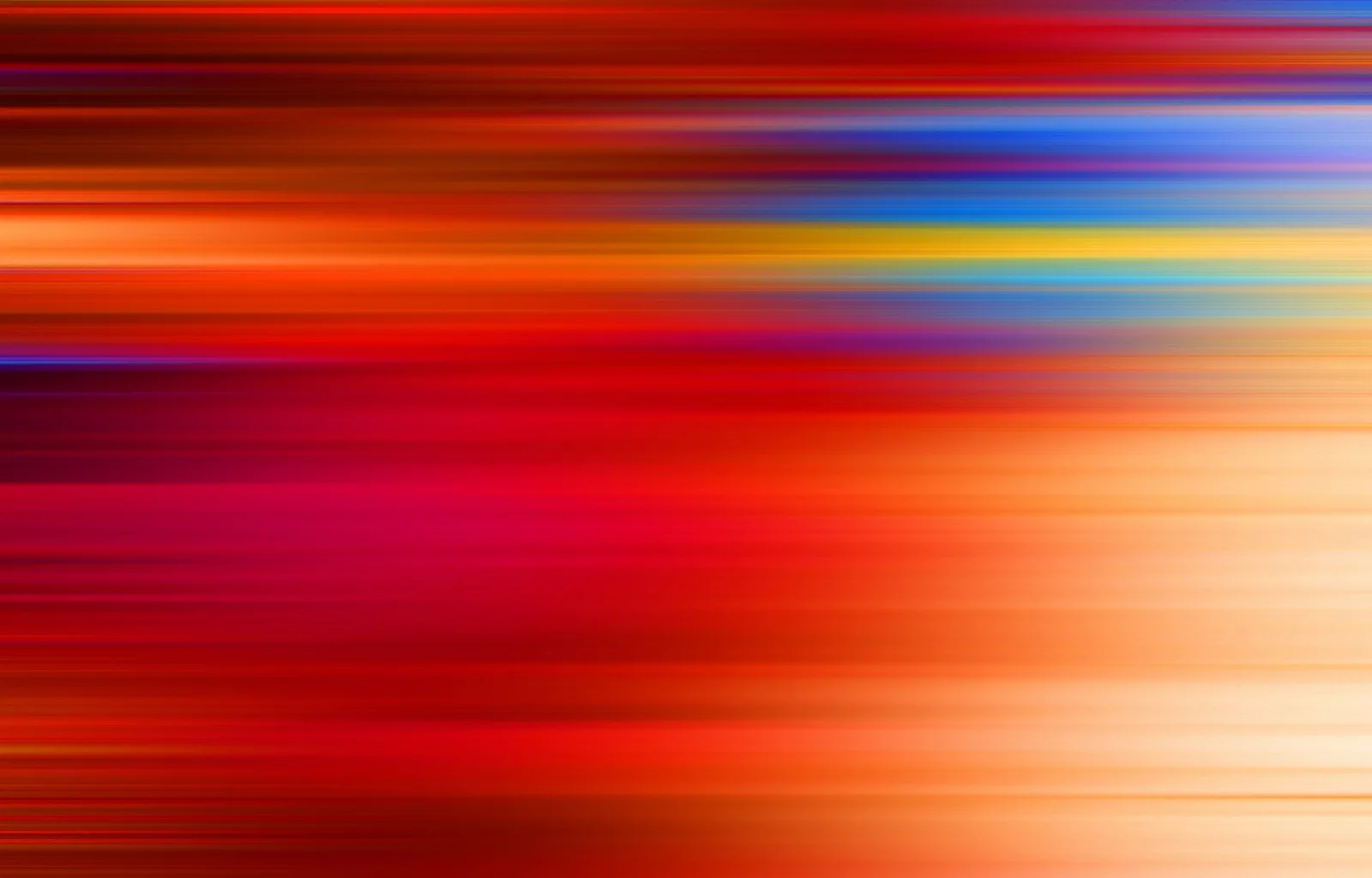Abstrakte horizontale Streifen in Rot, Orange, Gelb und Blau, die wie eine Bewegungsunschärfe von links nach rechts verlaufen.