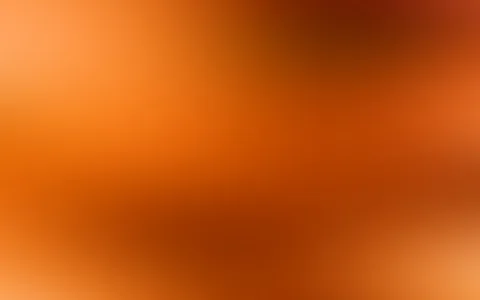 Weicher Farbverlauf von hellem Orange oben links über kräftiges Rostrot bis zu dunklen Brauntönen oben rechts und unten Mitte.