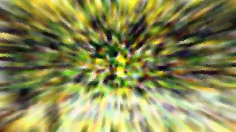 Abstrakte radiale Unschärfe in Gelb, Grün und Dunkelgrau, helle und dunkle Streifen laufen auf die Bildmitte zu.