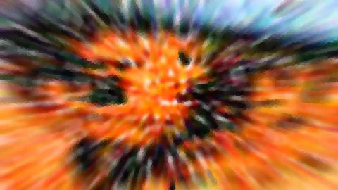Abstrakte, stark verwischte Komposition mit radialen Strahlen in Orange, Schwarz, Grün und Blau, die von einem hellen orangefarbenen Zentrum ausgehen.