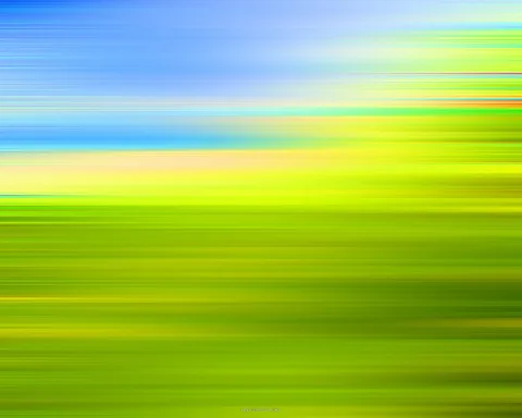 Horizontal verwischte Streifen in Blau, Gelb und Grün: oben Himmel, unten eine grüne Fläche.