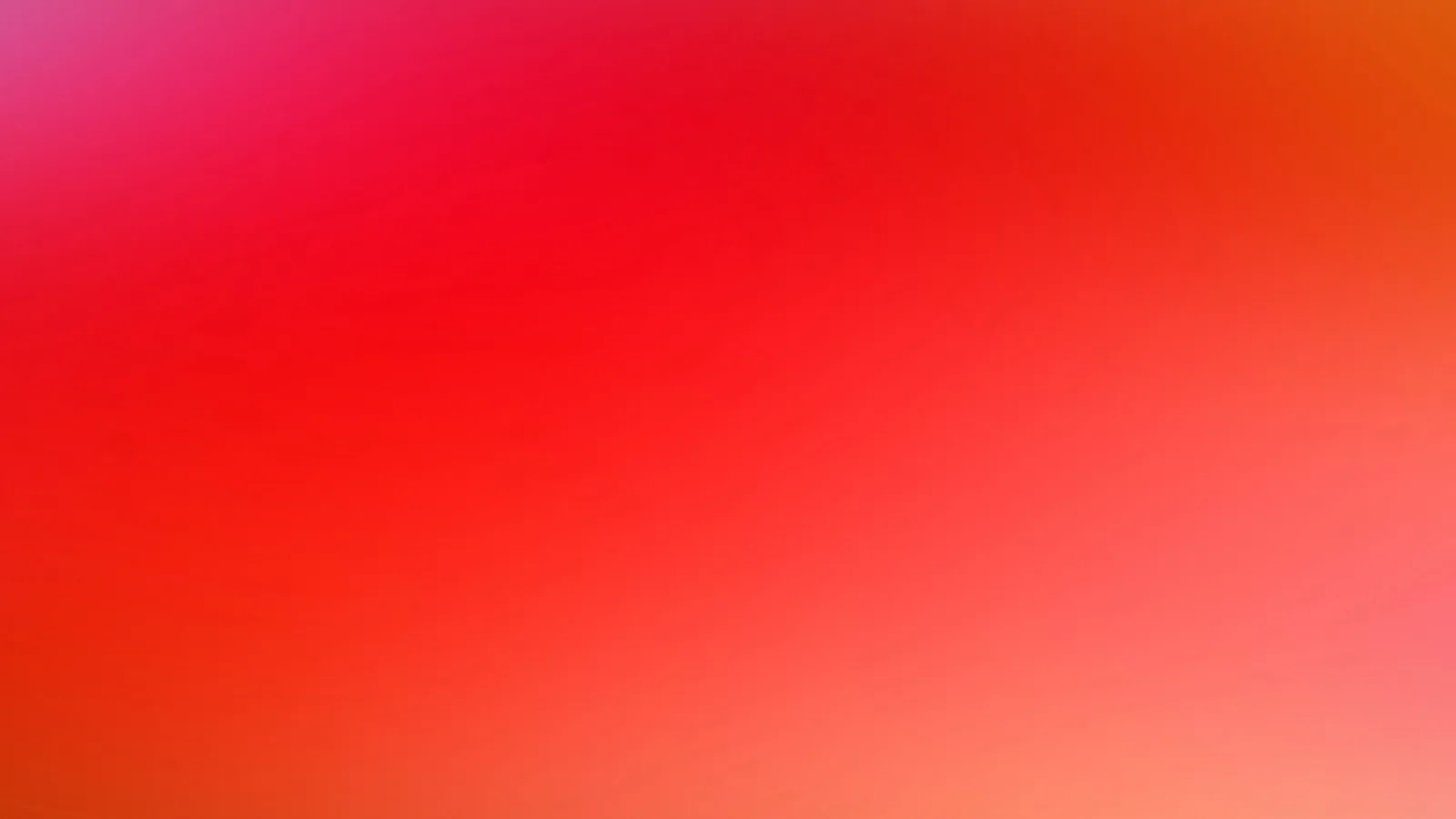 Weich verlaufender Farbverlauf von Rot über Pink bis Orange, ohne erkennbare Motive oder Formen.