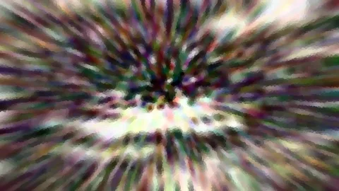 Abstraktes Bild mit radial von der Mitte nach außen laufenden, bunten Farbschlieren in Lila, Grün, Weiß und Dunkelblau, mosaikartig verpixelt.