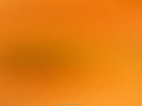 Flächiger orangefarbener Verlauf, von hellem Orange am unteren Rand bis zu dunklerem Orange in der linken Bildmitte, mit einer weichen, verschwommenen Schattenzone.