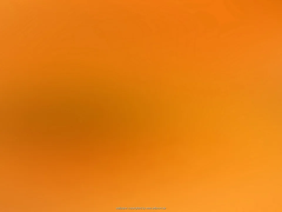 Flächiger orangefarbener Verlauf, von hellem Orange am unteren Rand bis zu dunklerem Orange in der linken Bildmitte, mit einer weichen, verschwommenen Schattenzone.