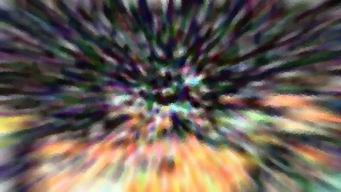 Abstrakte, radial verwischte Farbstrahlen in Grün, Violett und Orange, die von einem hellen Zentrum nach außen laufen.