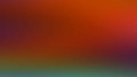 Unscharfer Farbverlauf: oben Rotorange, zu den Seiten hin Violett, am unteren Rand Grün und Blaugrün.