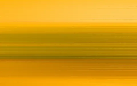 Horizontal verwischte Streifen in Gelb, Orange und Olivgrün, die von oben nach unten ineinander übergehen.