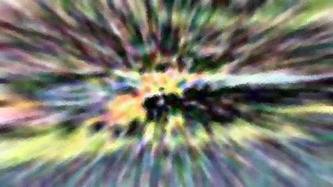 Bunte Farbstreifen laufen von einem dunklen Zentrum radial nach außen, das Bild wirkt mosaikartig verpixelt.