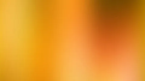Weich verschwommener Farbverlauf von Gelb über Orange bis Braun und Rosa, dunkler Bereich oben rechts.