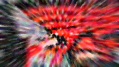 Abstraktes Bild mit rot, grün und violett, das von einem Zentrum in radialen Streifen nach außen strahlt und mosaikartig verpixelt wirkt.
