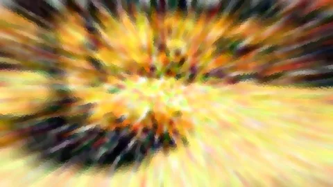 Abstraktes Bild mit radialer Unschärfe, von einem hellen gelben Zentrum strahlen Streifen in Orange, Grün und Dunkelbraun nach außen.