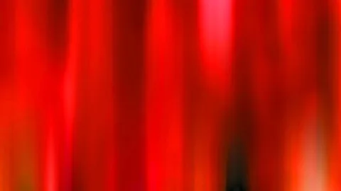 Abstrakte, vertikal verwischte Streifen in Rot und Rosa mit einem dunklen Fleck unten rechts.