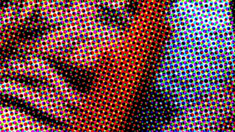 Dichtes Raster aus bunten Punkten in Rot, Gelb, Blau, Grün und Magenta, dazwischen schwarze Flecken.