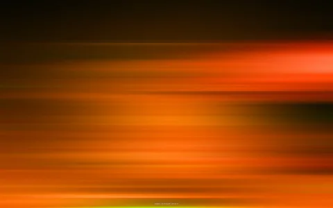 Horizontale, verwischte Streifen in Orange, Rot und Gelb vor dunklem Hintergrund, mit hellerem Leuchten rechts oben und einem dunklen Fleck rechts unten.