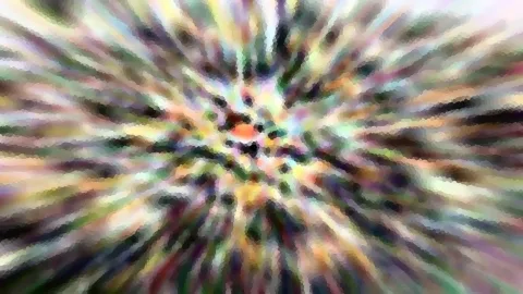 Abstrakte Komposition aus bunten, gepixelten Streifen, die radial von einem orangefarbenen Punkt in der Mitte nach außen laufen.