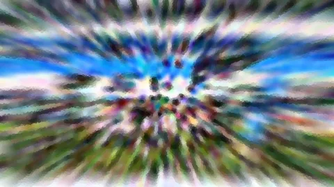 Abstrakte Verwischung mit radialem Zoomeffekt: blauer Himmel, grüne Flächen und bunte Schlieren, die vom Zentrum nach außen laufen