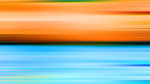 Abstrakte Bewegungsunschärfe mit horizontalen Streifen: oben warmes Orange und Gelb, unten helles Blau und Türkis, getrennt durch einen dunklen Übergang.