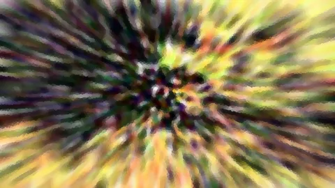 Abstrakte radiale Unschärfe mit gelben, grünen und violetten Streifen, die von einem dunklen Zentrum nach außen laufen.