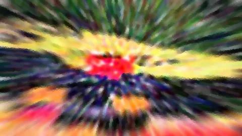 Abstrakte Zoomaufnahme mit radialen Streifen in Rot, Gelb, Grün und Blau, im Zentrum ein leuchtend roter Fleck.