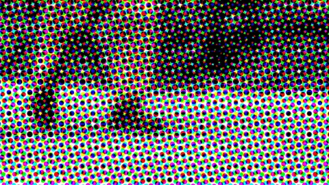 Dichtes Raster aus farbigen Punkten in Rot, Grün, Blau, Gelb und Magenta, im oberen Bereich verdichtet sich das Schwarz zu einer dunklen Form.