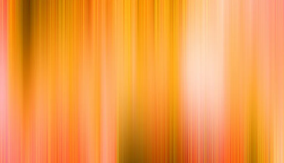 Abstrakte, vertikal verwischte Streifen in Orange, Gelb und Rosa mit einem hellen Lichtfleck rechts der Mitte.