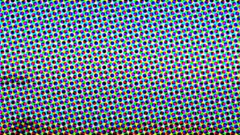 Dichtes Raster aus kleinen runden Punkten in Rot, Grün, Blau, Cyan, Magenta, Gelb und Schwarz auf weißem Grund.