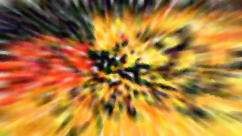 Abstrakte Aufnahme mit radialer Unschärfe in Orange, Gelb, Rot und Grün, im Zentrum dunkle Flecken.