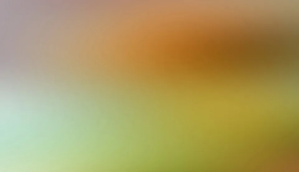 Unscharfer Farbverlauf von Orange und Braun im oberen Bereich, der nach unten in Grün und Gelbgrün übergeht.