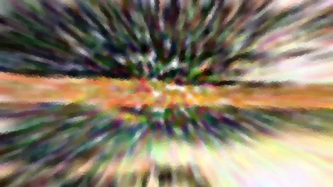 Abstraktes Bild mit radialen Schlieren in Grün, Orange, Violett und Weiß, mosaikartig gepixelt, das Zentrum leuchtet hell.