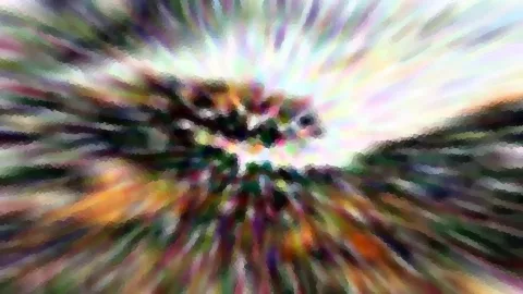 Abstrakte, farbige Radialunschärfe mit grob gepixelten Strahlen um einen dunklen, verschwommenen Mittelpunkt.