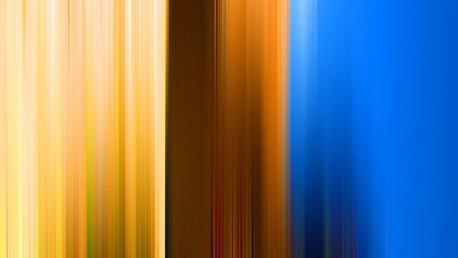 Vertikal verwischte Streifen laufen von links nach rechts durch Gelb, Orange, Braun und Blau.