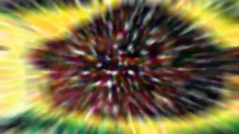 Abstrakte Komposition mit radialer Unschärfe: ein dunkles, pixeliges Zentrum mit roten und violetten Tönen, umgeben von gelben und grünen Strahlen.