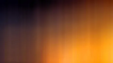 Unscharfe vertikale Streifen, oben dunkelblau, unten und rechts leuchtend orange.