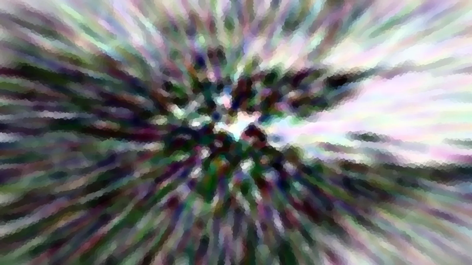 Abstrakte radiale Unschärfe mit grünen, violetten und weißen Schlieren, die von einem hellen Zentrum nach außen laufen.