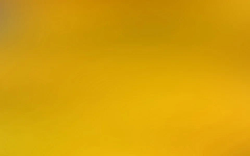 Unscharfer Verlauf in Gelb- und Ockertönen, von dunkleren Orangetönen oben zu hellem Gelb unten, ohne erkennbare Motive.