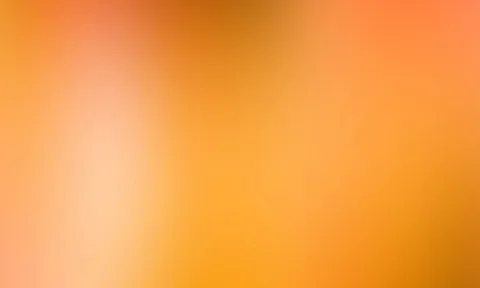 Unscharfer Verlauf in Orange und Gelb mit einem helleren Lichtfleck links und dunkleren Bereichen rechts oben.