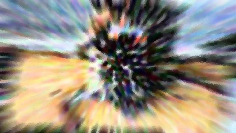 Abstraktes Bild mit radialem Zoomeffekt: Dunkle, buschige Form in der Mitte, umgeben von gelben, blauen und violetten Farbstreifen, die sich nach außen auflösen.
